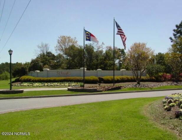 view of property's community with a lawn