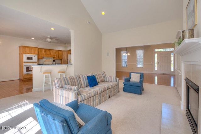 4315 Loblolly Cir SE, Southport, NC 28461 - living room with recessed lighting, ceiling fan, baseboards, high vaulted ceiling, and light carpet
