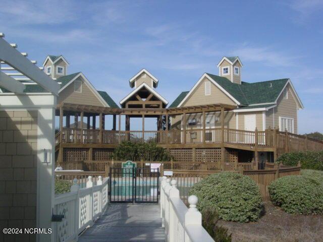 4315 Loblolly Cir SE, Southport, NC 28461 - view of building exterior featuring a community pool and fence