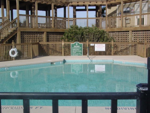 view of swimming pool featuring a deck