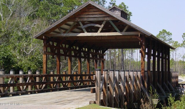 view of community featuring a gazebo and a wooden deck