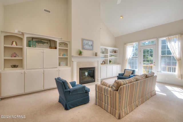 living room featuring light carpet and high vaulted ceiling