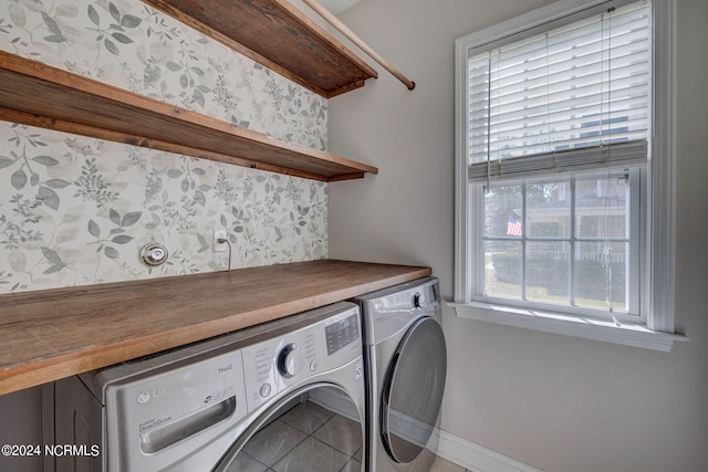 clothes washing area featuring washer and dryer and tile patterned floors