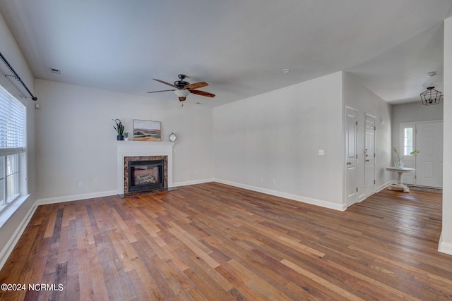 unfurnished living room with hardwood / wood-style flooring, a fireplace, and ceiling fan