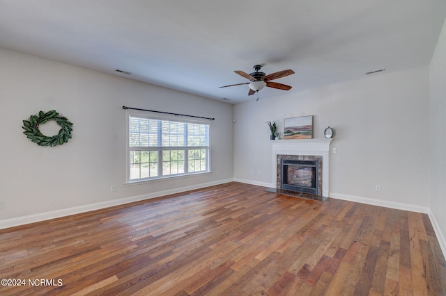 unfurnished living room with ceiling fan and hardwood / wood-style flooring