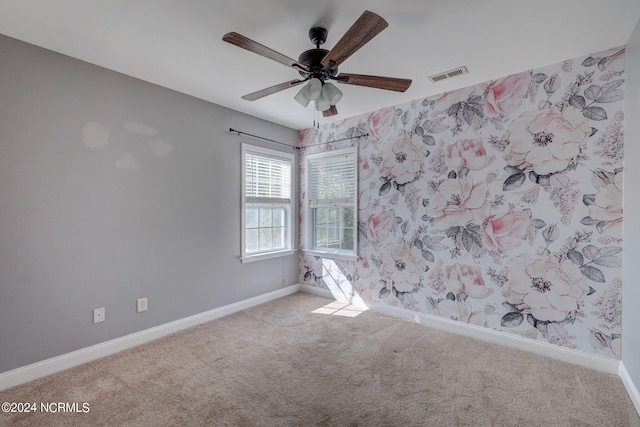 carpeted empty room with ceiling fan