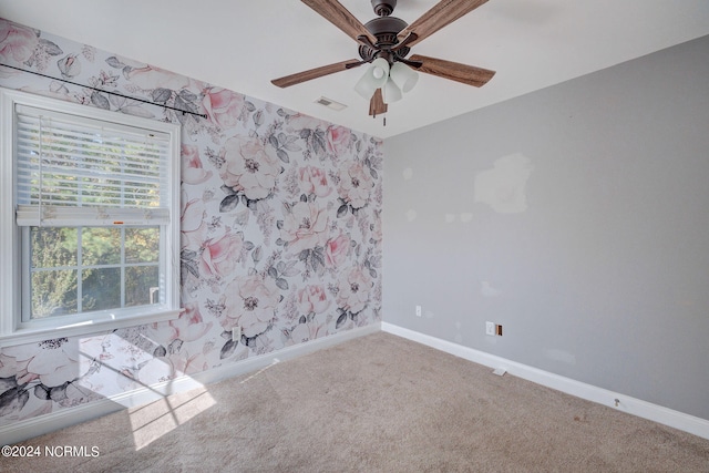 carpeted empty room featuring ceiling fan