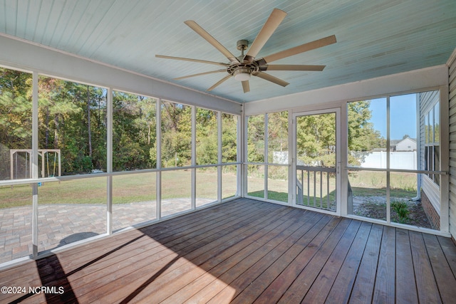 unfurnished sunroom featuring ceiling fan