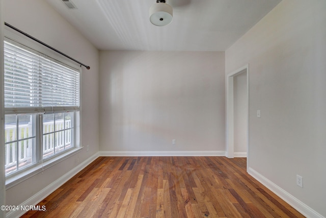 unfurnished room featuring dark hardwood / wood-style flooring