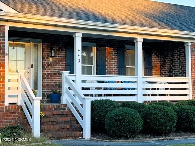 doorway to property featuring a porch