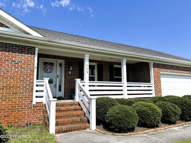 117 Buds Ln, Cedar Point, NC 28584 - property entrance featuring brick siding, a garage, and a porch