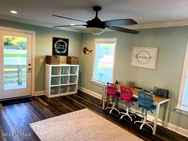 home office with ceiling fan, ornamental molding, and dark wood-type flooring