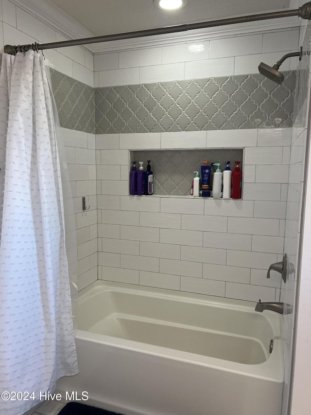 bathroom featuring shower / tub combo with curtain and ornamental molding