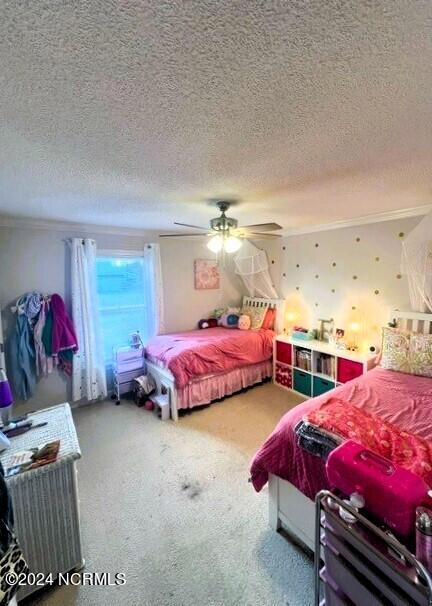 bedroom with a textured ceiling and ceiling fan