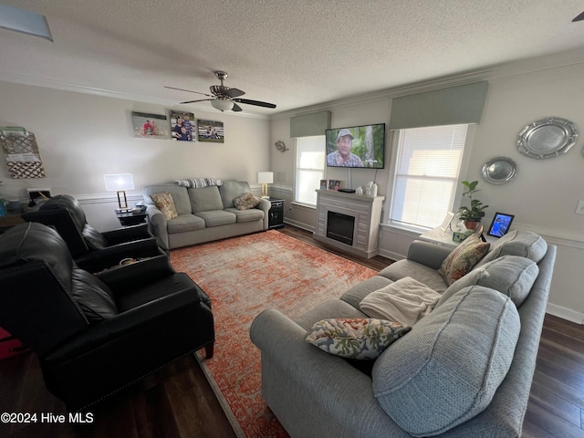 living room with dark hardwood / wood-style flooring, ornamental molding, and a textured ceiling