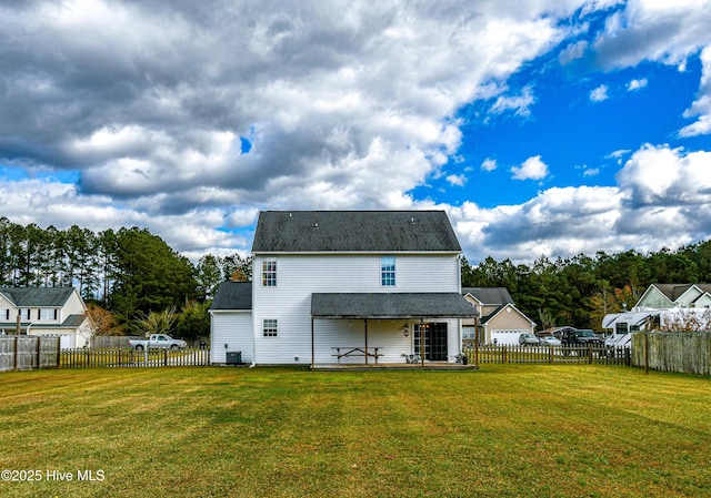 rear view of property with a yard and central AC