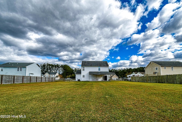 rear view of property with a yard