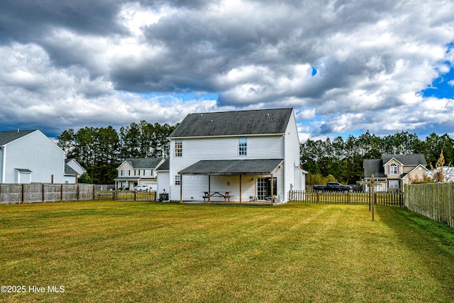 rear view of house with a patio area and a yard