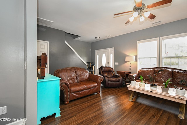 living room featuring ceiling fan and dark hardwood / wood-style flooring