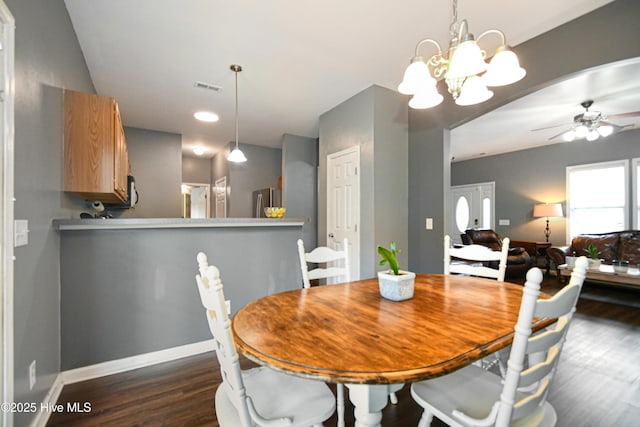 dining room with dark wood-type flooring and ceiling fan