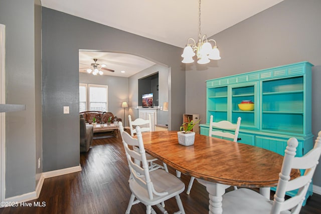 dining room featuring ceiling fan with notable chandelier and dark hardwood / wood-style floors