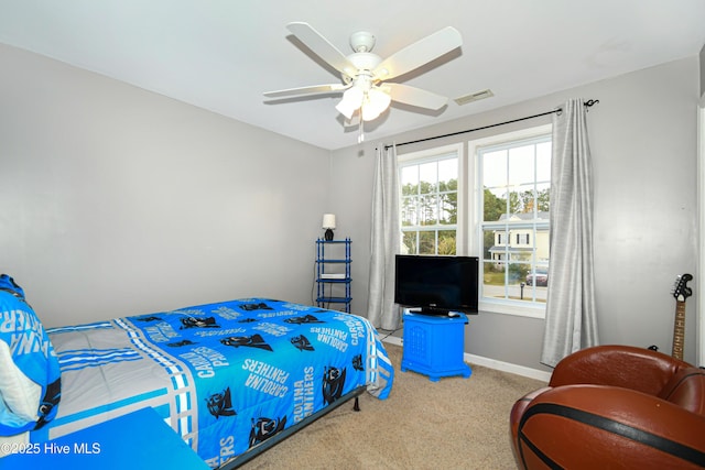 bedroom featuring ceiling fan and carpet