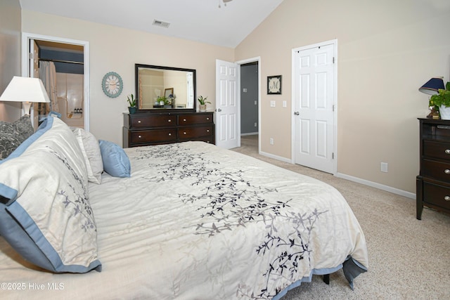 carpeted bedroom with lofted ceiling