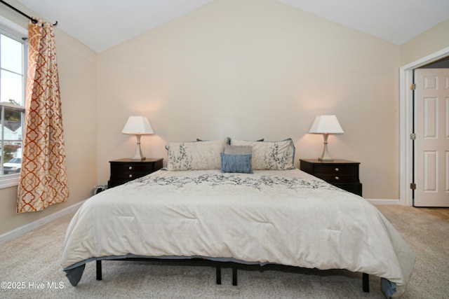 carpeted bedroom featuring lofted ceiling