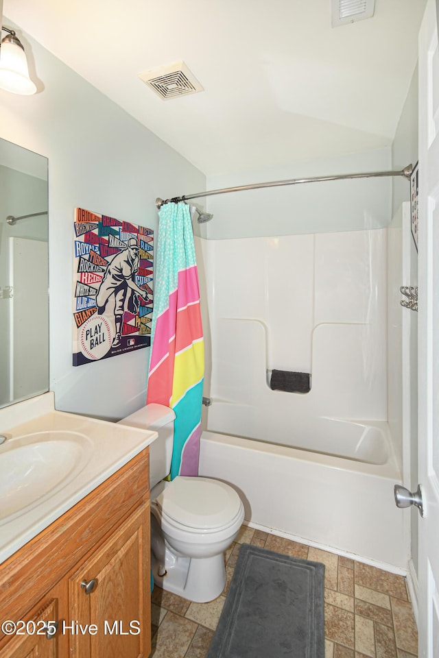 full bathroom featuring toilet, shower / tub combo with curtain, and vanity