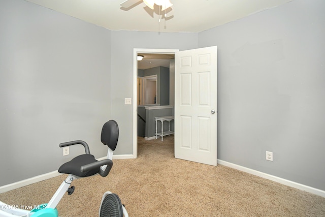 workout area featuring ceiling fan and light carpet