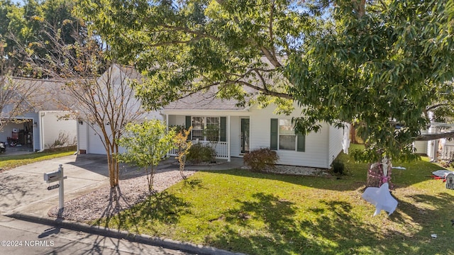 view of front facade with a porch, a front yard, and a garage