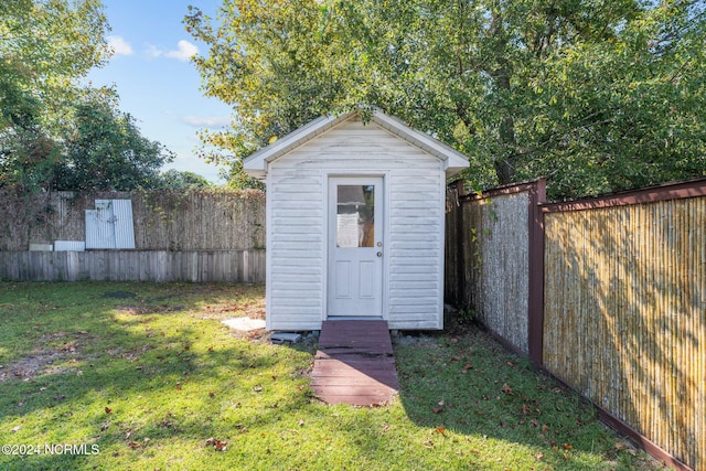 view of outbuilding with a yard