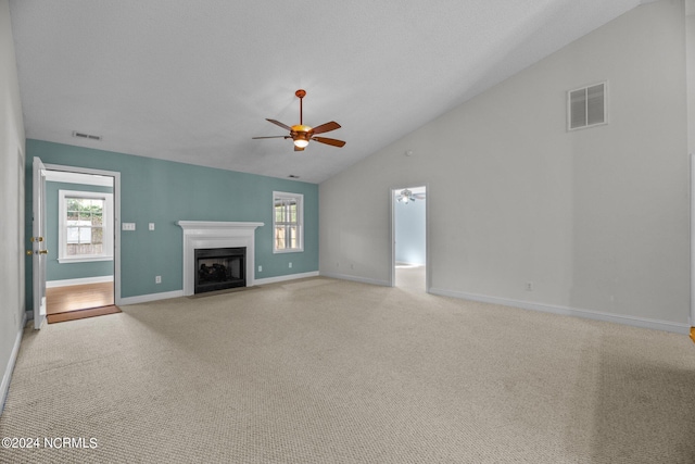 unfurnished living room featuring light carpet, a healthy amount of sunlight, and ceiling fan