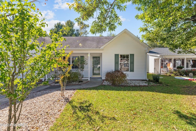 ranch-style home with a front yard and a porch