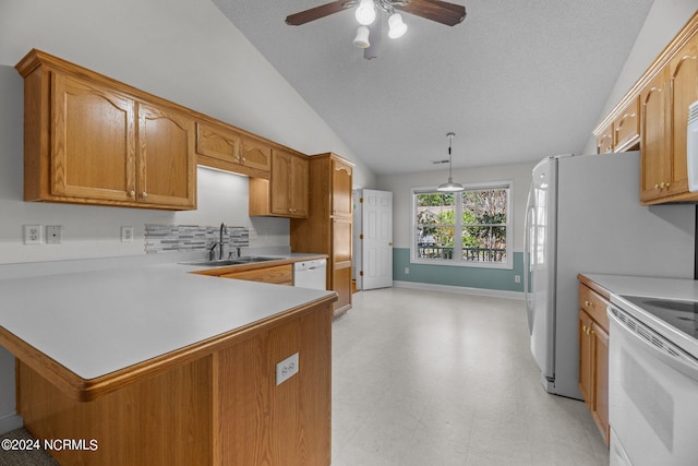 kitchen with kitchen peninsula, lofted ceiling, ceiling fan, pendant lighting, and sink