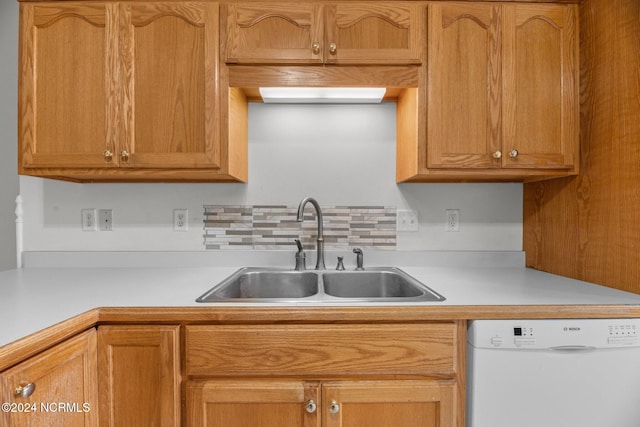 kitchen featuring sink, dishwasher, and decorative backsplash