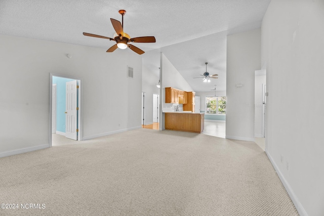 unfurnished living room featuring light colored carpet, high vaulted ceiling, and ceiling fan