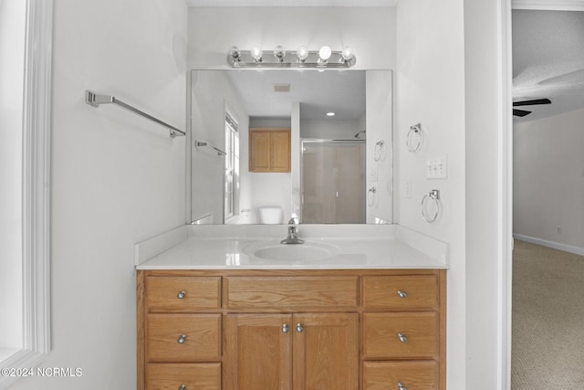 bathroom featuring vanity and a shower with shower door