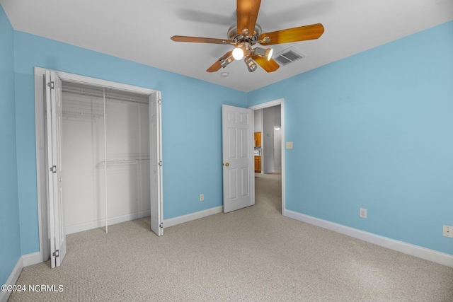 unfurnished bedroom with light colored carpet, a closet, and ceiling fan