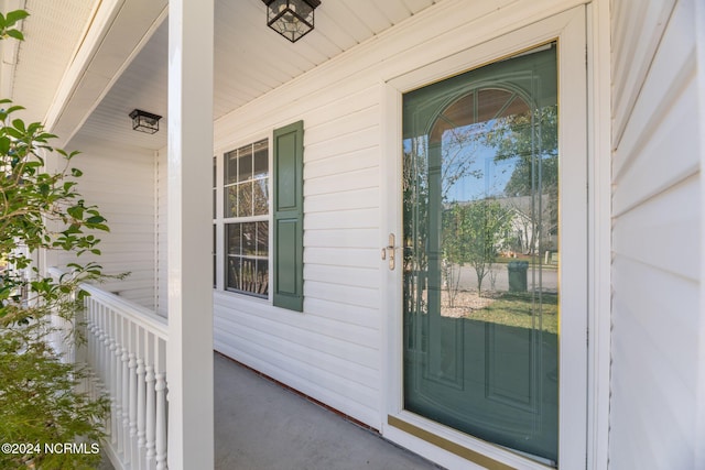 view of exterior entry featuring a porch