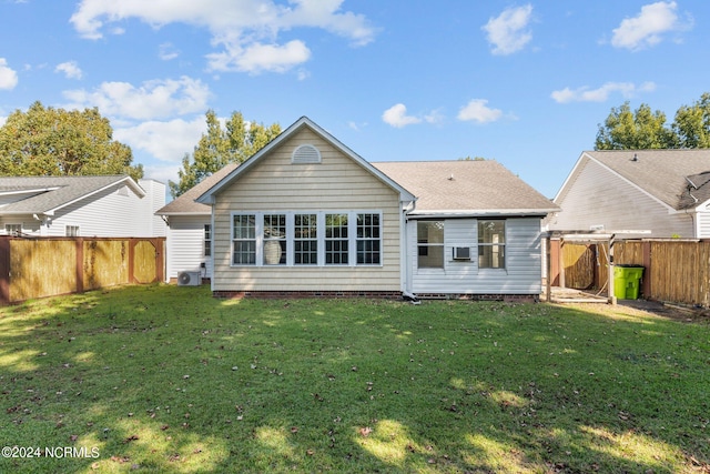 back of property with cooling unit and a lawn