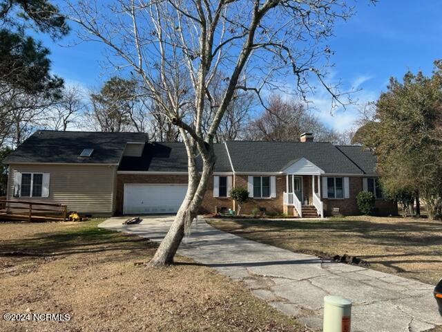 ranch-style home with a front yard and a garage