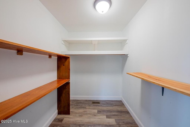 spacious closet featuring hardwood / wood-style floors