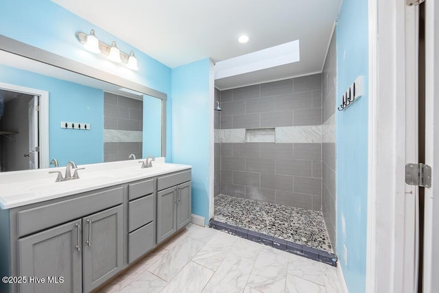 bathroom with vanity and a tile shower