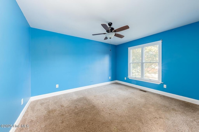 carpeted empty room featuring ceiling fan