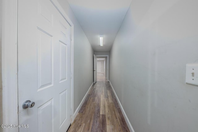 hallway with hardwood / wood-style floors