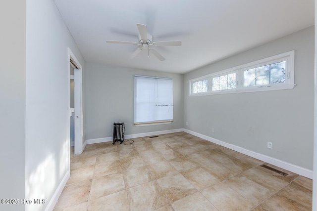 empty room with ceiling fan and radiator heating unit