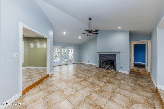 unfurnished living room with vaulted ceiling, ceiling fan, light tile patterned floors, and a fireplace