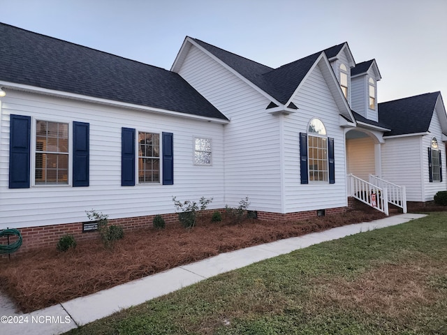 view of side of property with a yard