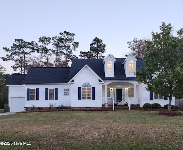 cape cod house with a garage, a front yard, and covered porch